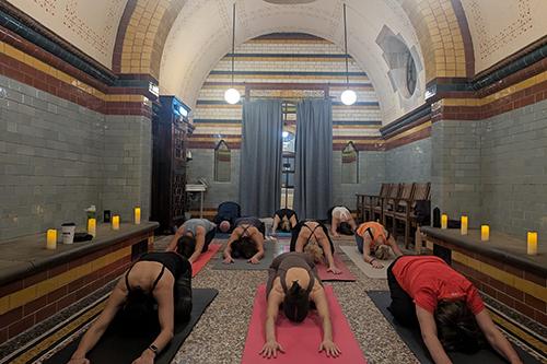 Several adults having a hot yoga experience