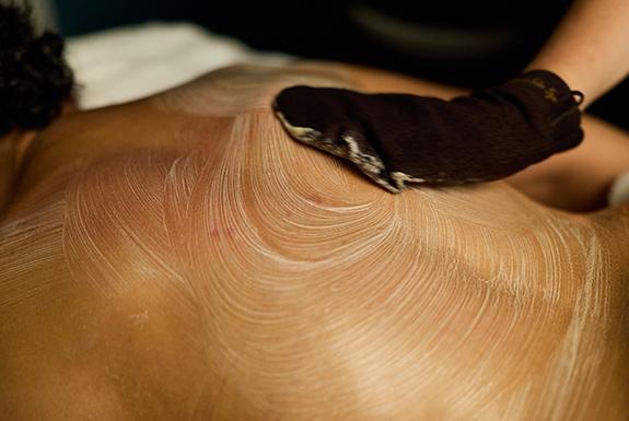 adult lying on their front having a revitalising hammam ritual treatment